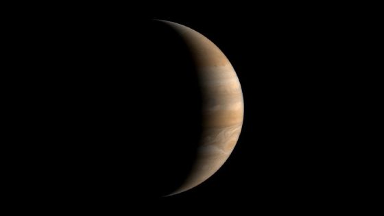 An image of Jupiter mostly shielded in shadow