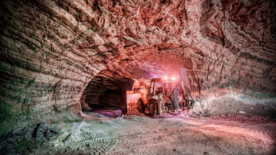 Image of an excavated area deep below ground, with some machinery furthering the excavation.