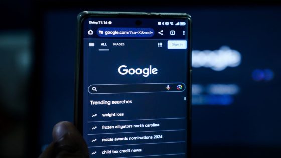 A phone showing the Google search screen against a dark backdrop.