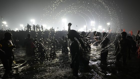 Hindu ascetic rising from the river after a holy dip is emblematic of Maha Kumbh festival in India