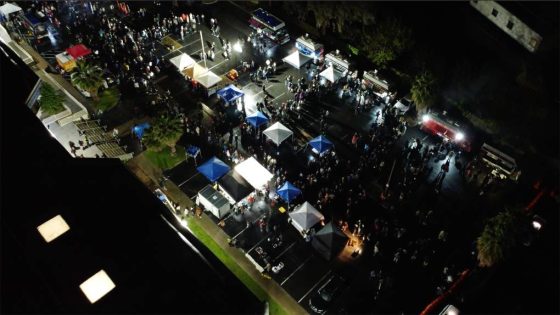 Still image of a drone video showing a night market festival from overhead.