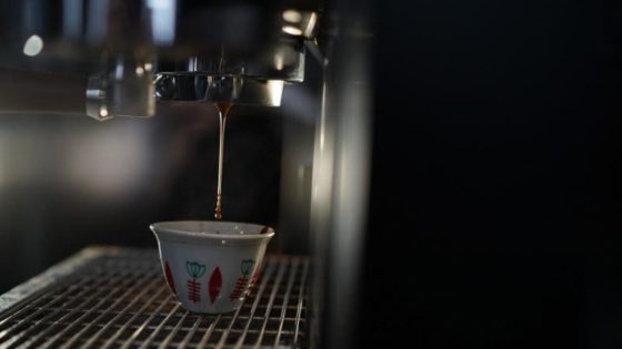 a cup of espresso being brewed