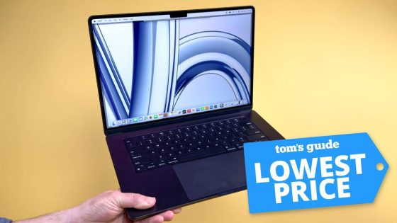 MacBook Air M3 15-inch in hand with Tom's Guide Lowest Price badge