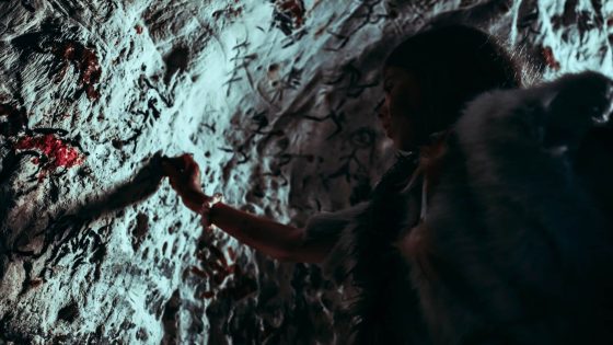 Primitive Prehistoric Neanderthal Child In Animal Skin Draws Animals And Abstracts On Walls At Night