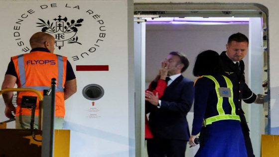 Macron's face appears to be shoved by wife in Vietnam