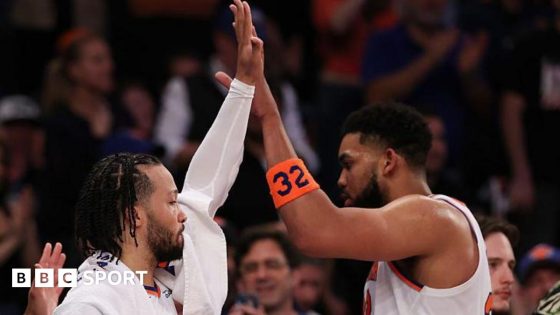 New York Knicks' Jalen Brunson high-fives team-mate Karl-Anthony Towns