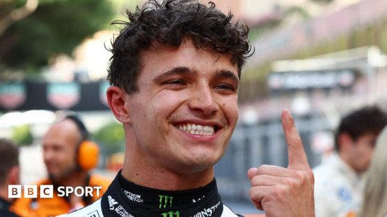 Lando Norris holds up his index finger in celebration after winning the Monaco Grand Prix