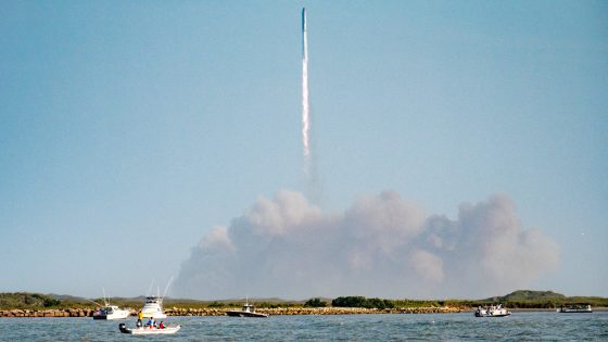 A giant rocket launches toward space while people watch from nearby boats in Texas