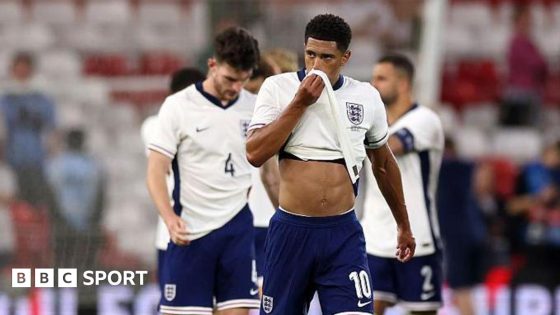 Jude Bellingham wipes his face with his shirt after England's 3-1 defeat by Senegal