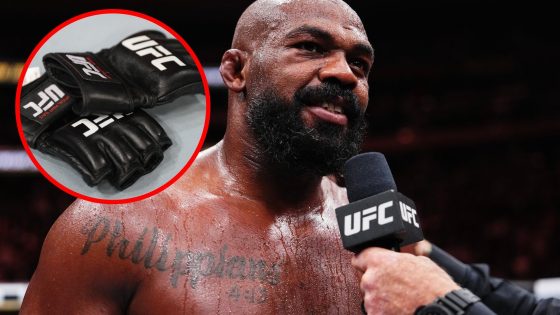 Jon Jones speaks after his win at UFC 309, inset detailed view of UFC gloves on the Octagon floor.