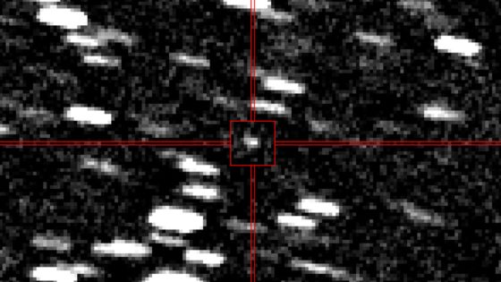 Blurry photo of a point of light shooting though a starry background