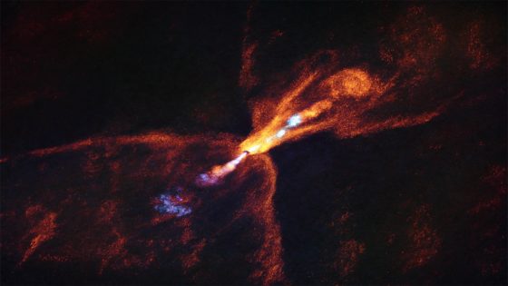 This is HOPS-315, a baby star where astronomers have observed evidence for the earliest stages of planet formation. Together with data from the James Webb Space Telescope (JWST), these observations show that hot minerals are beginning to solidify. In orange we see the distribution of carbon monoxide, blowing away from the star in a butterfly-shaped wind. In blue we see a narrow jet of silicon monoxide, also beaming away from the star. These gaseous winds and jets are common around baby stars like HOPS-315. Credit: ALMA(ESO/NAOJ/NRAO)/M. McClure et al.