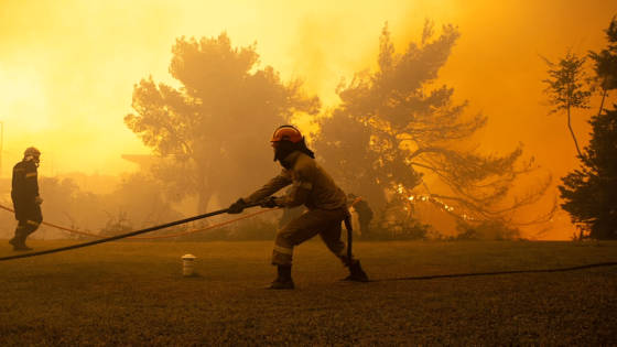 Image of firefighters battling a wildfire. Forest fire Corinth.