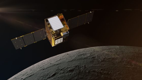 a cube-shaped gold foil-wrapped spacecraft above a grey, dusty orb