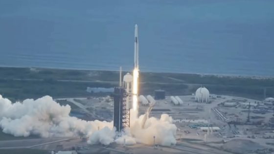 A rocket seen shooting upward with a coastline in the background.