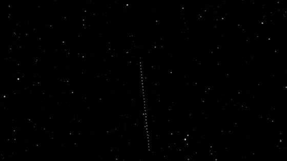 A line of white dots against a dark background