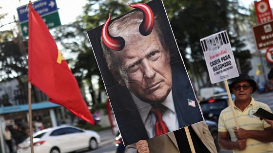 A demonstrator holds an image of U.S. President Donald Trump with red horns during a protest against the tariffs on Brazilian products imposed by Trump.
