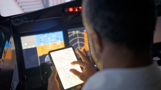 Photo of a pilot using an iPad in the cockpit.
